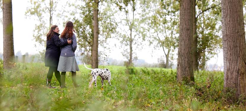 Anna en gezinshuisouder Katja wandelen met de hond.